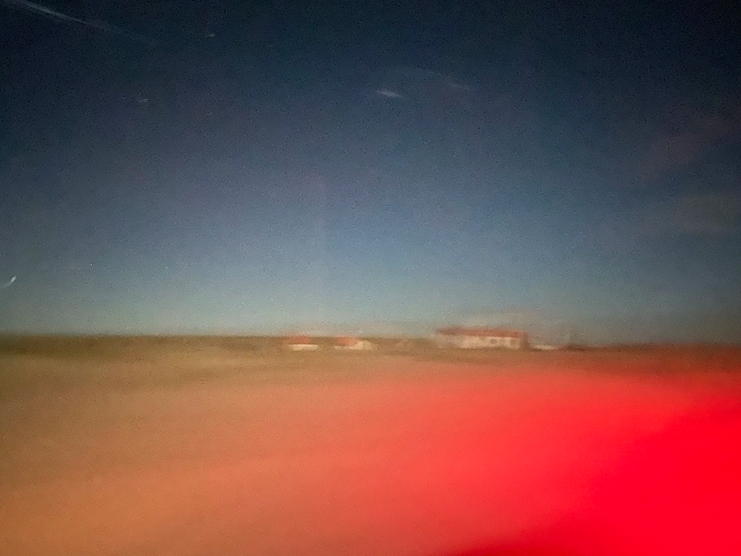 Desert horizon blurred by motion and red light